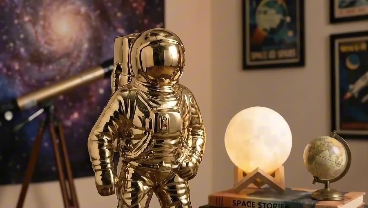 Liv & Skye Gold 6 in. x 11 in. Ceramic Astronaut Contemporary
