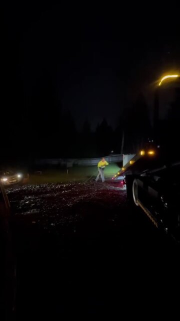 Photo of Tow World Towing - Renton, WA, US. Renton towing company doing vehicle stuck in mud by winch out on flatbed tow truck