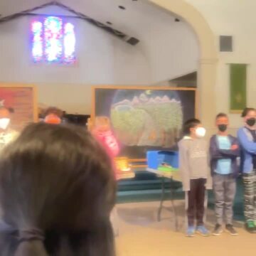 Photo of Maple Village Waldorf School - Long Beach, CA, US. 4rth graders singing on their animal project presentation.