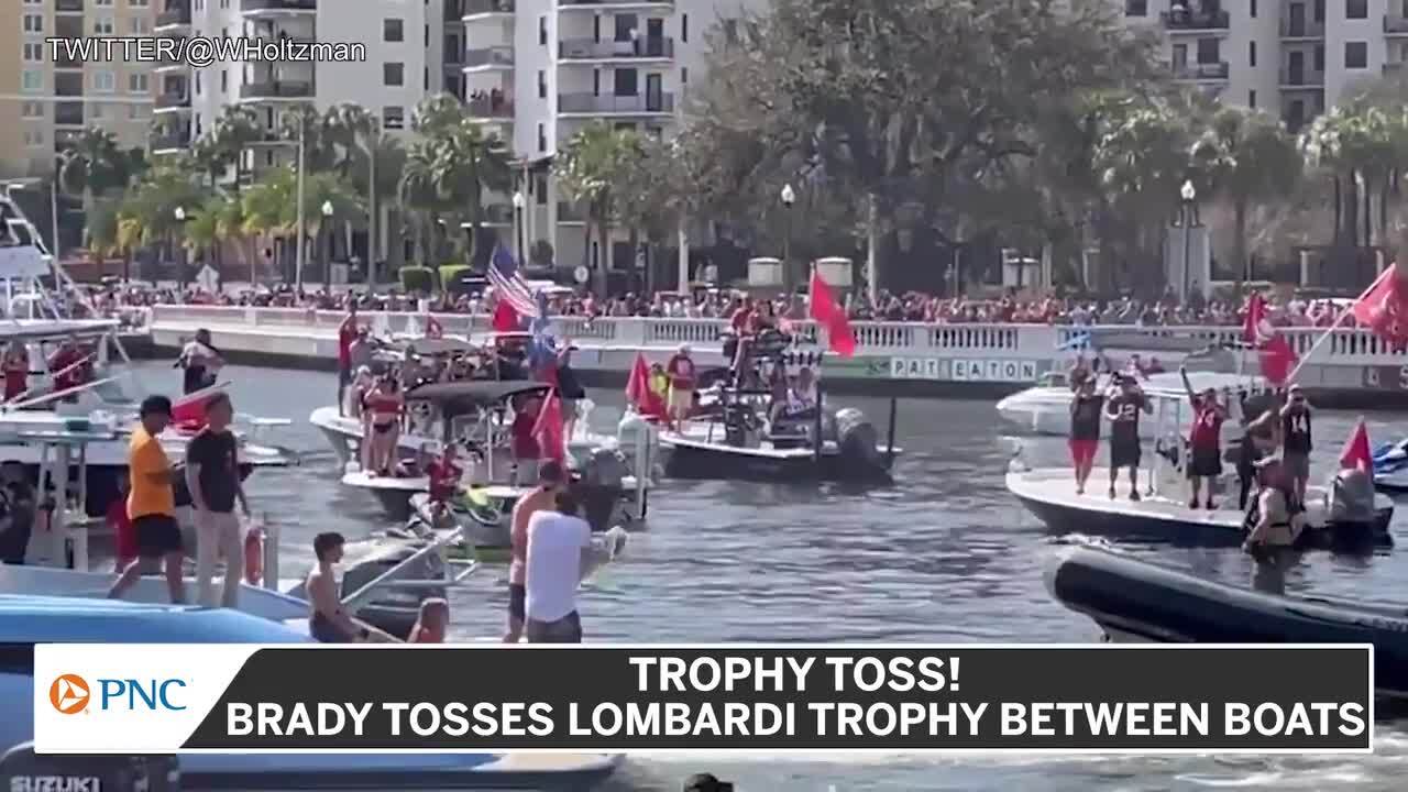 Tom Brady tosses Lombardi Trophy to Brate in another boat during Super Bowl  boat parade