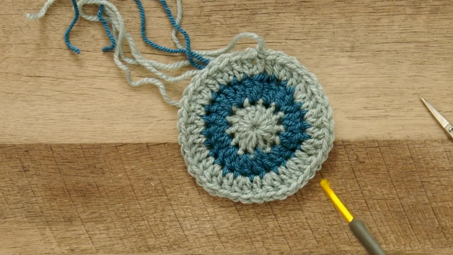 Worked gold-colored crochet or knitting ring, a yarn tension aid for  crocheting and knitting.