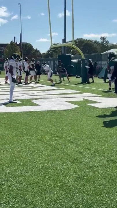 Michigan State football players thud up at training camp practice