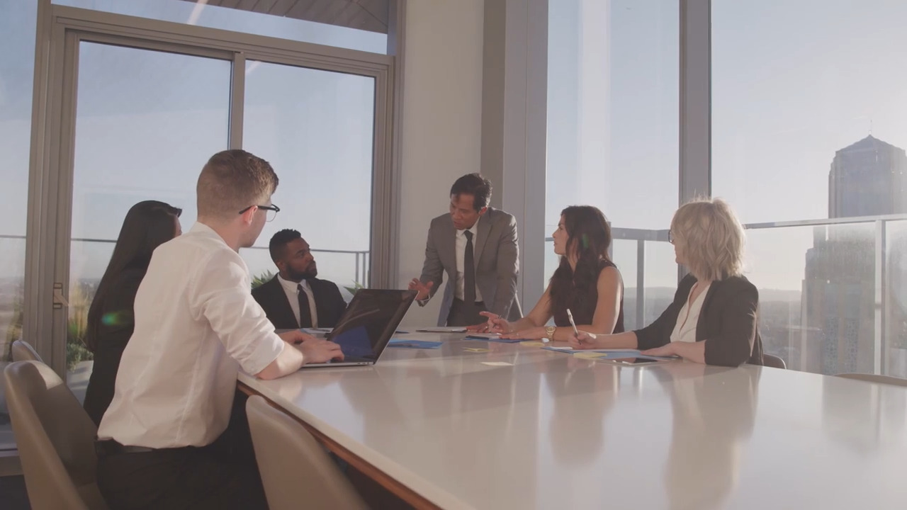 Diverse group of businesspeople sitting around a table 