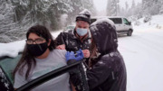 Stranded Health Workers Give COVID-19 Vaccines to Drivers on Snowy Highway