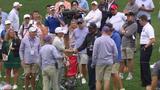 Mackenzie Hughes reaches green after ball drills cameraman