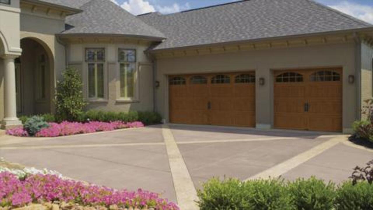 Gallery Collection 16 ft. x 7 ft. 18.4 R-Value Intellicore Insulated  Ultra-Grain Walnut Garage Door with Arch Window