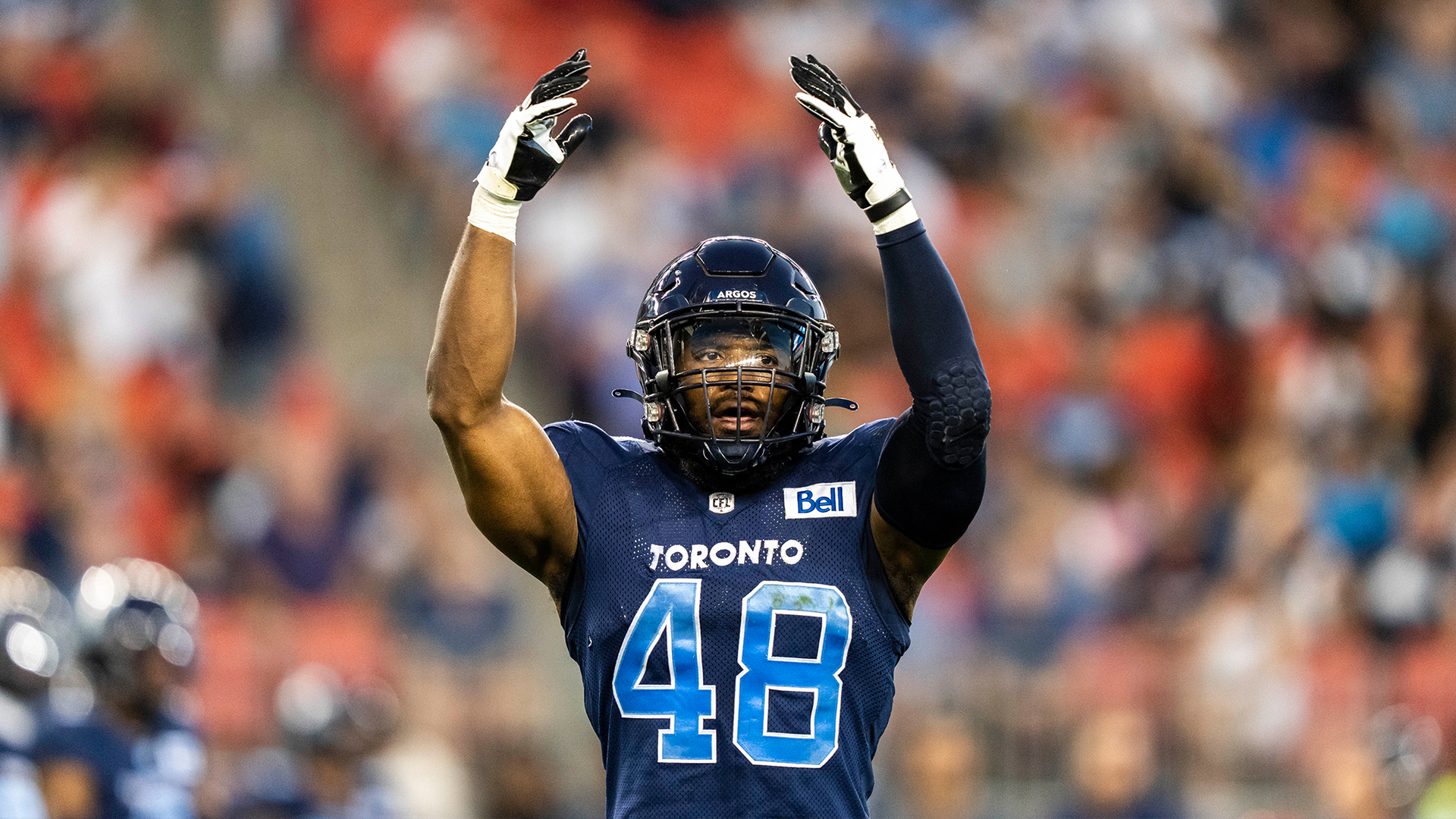 Toronto Argonauts players look at the CFL East division trophy after  defeating the Montreal Alouettes in