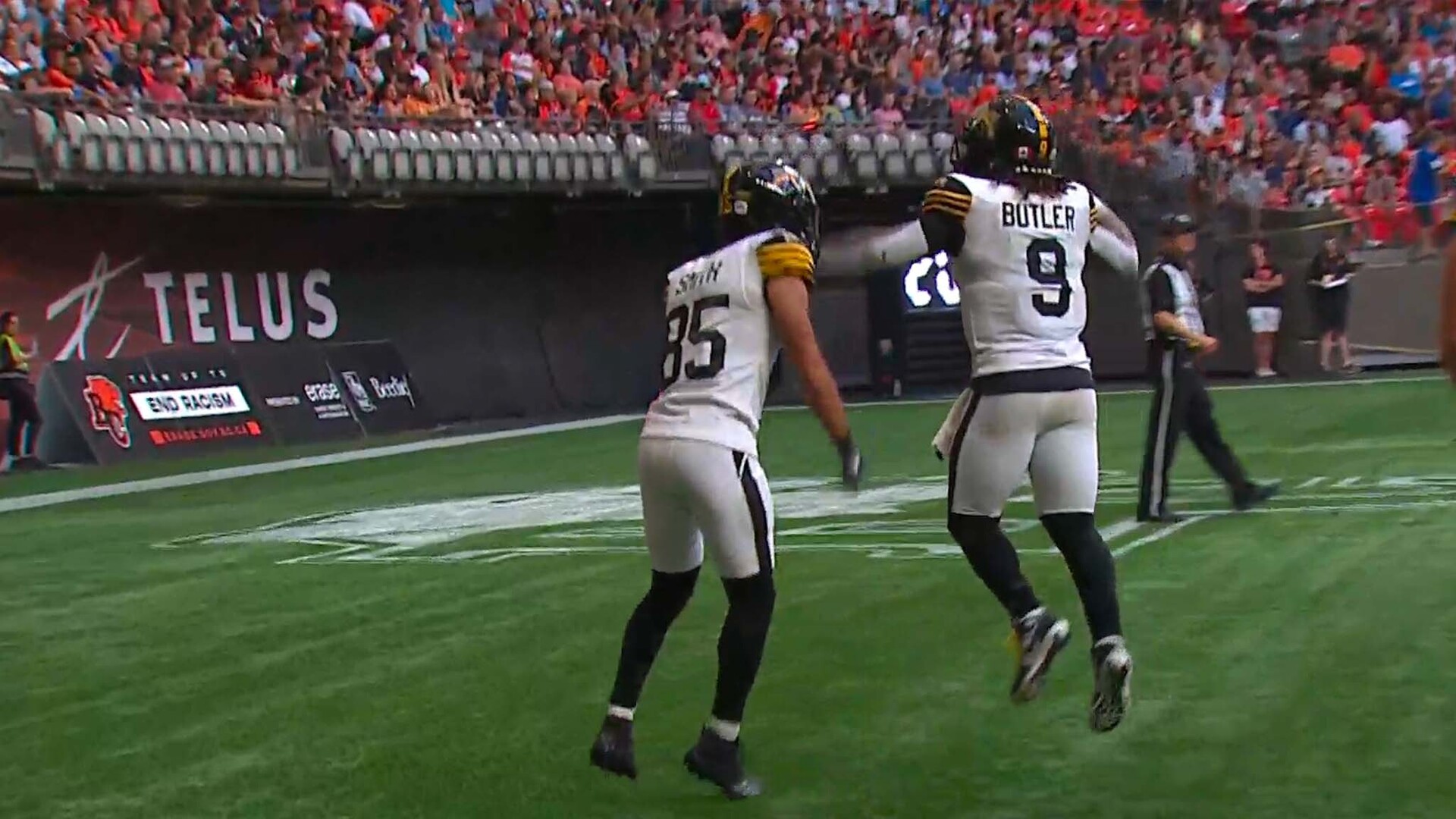 BC Lions' Justin McInnis (18) is tackled by Hamilton Tiger-Cats