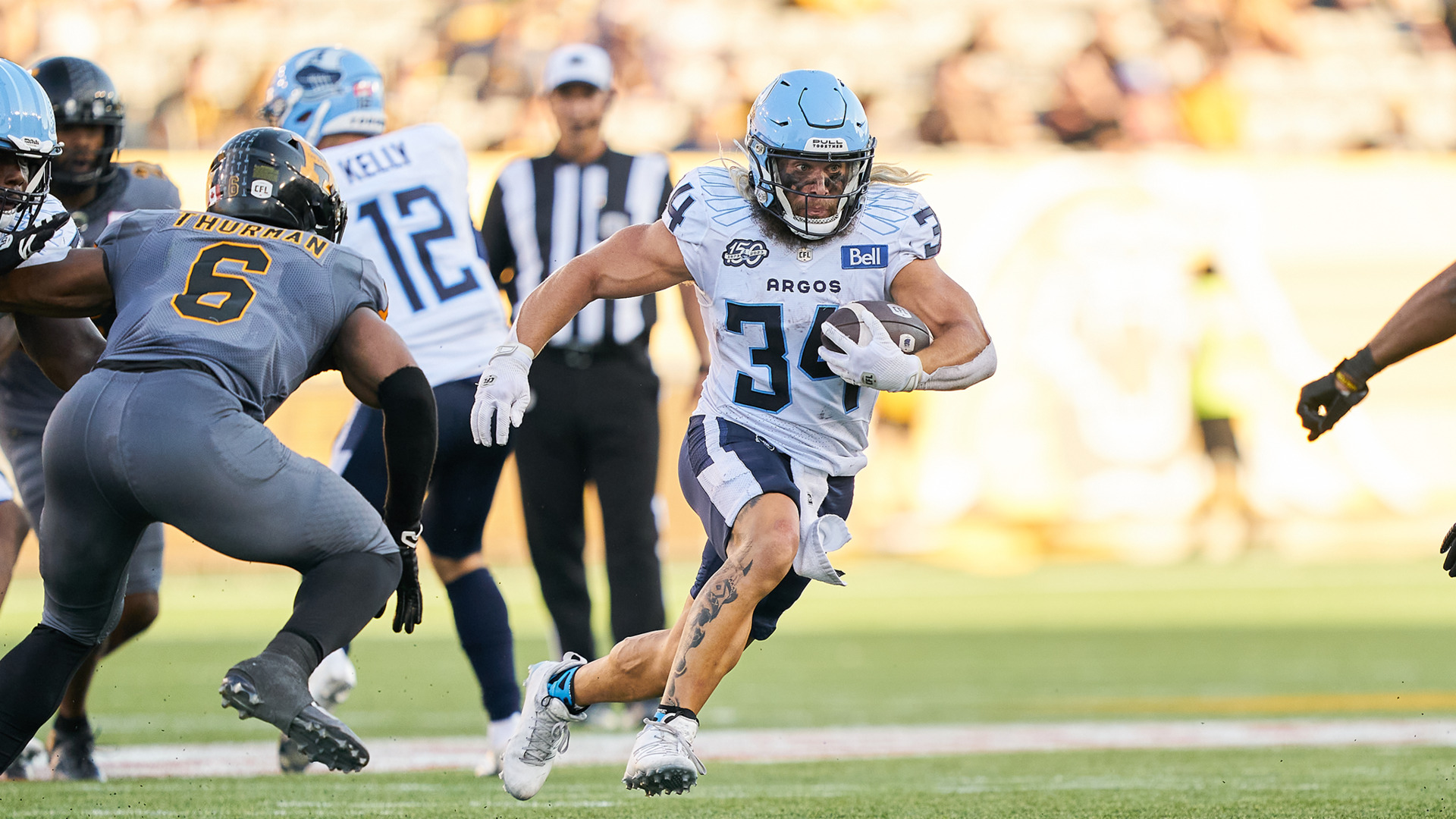 Hamilton Tiger-Cats defensive back Javien Elliott hands the ball