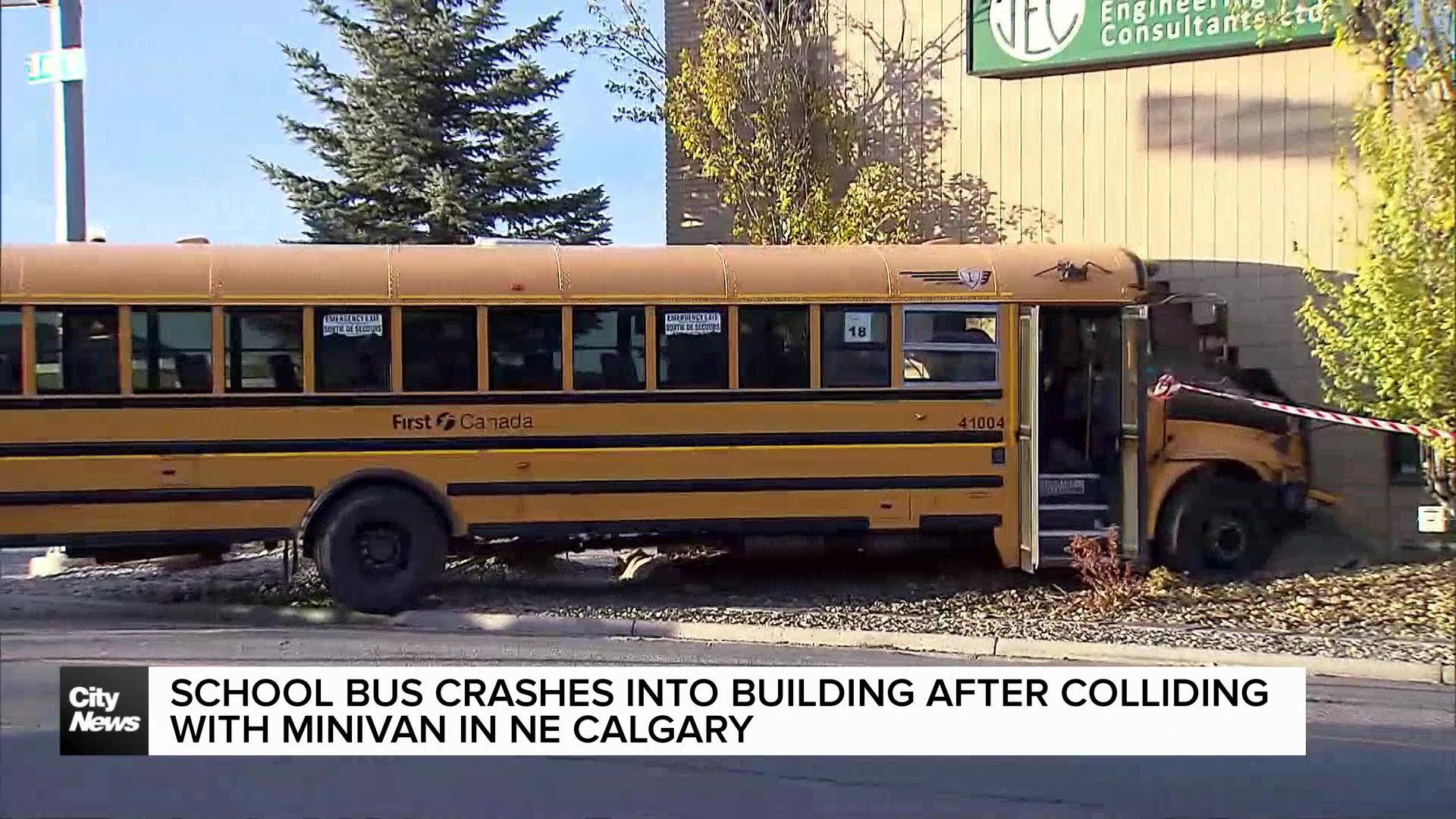 School bus crashes into building after colliding with minivan in NE Calgary