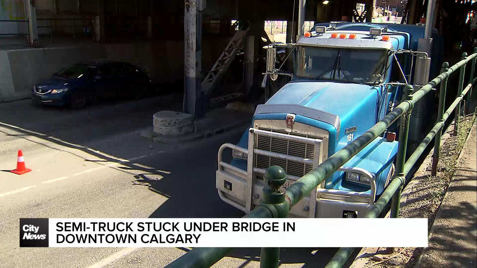 Semi-truck stuck under bridge in downtown Calgary