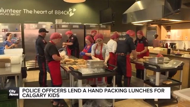 Police officers lend a hand packing lunches for Calgary kids