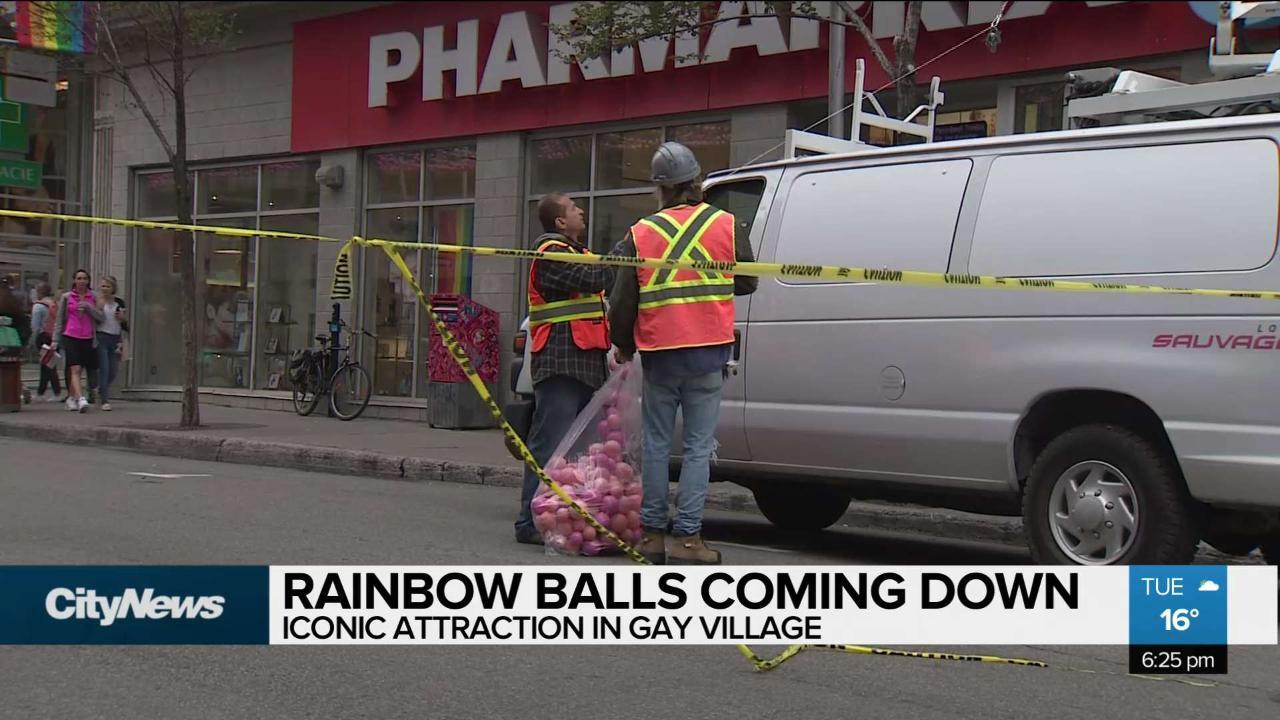 Rainbow balls over Gay Village coming down