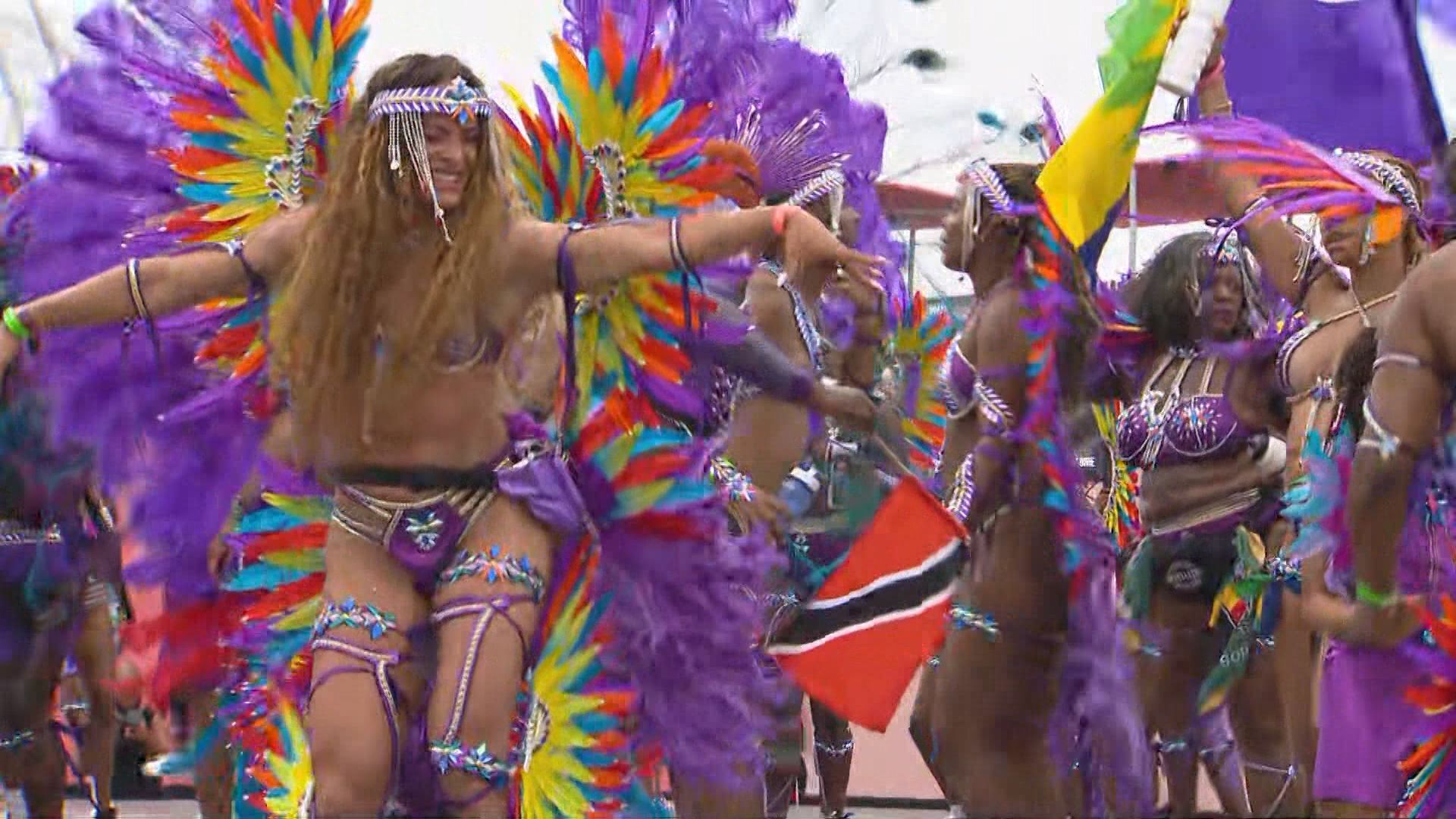 Revellers jump and wave at the 2024 Toronto Caribbean Carnival