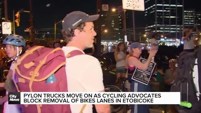 Pylon trucks leave as cyclists rally to block removal of bike lanes in Etobicoke