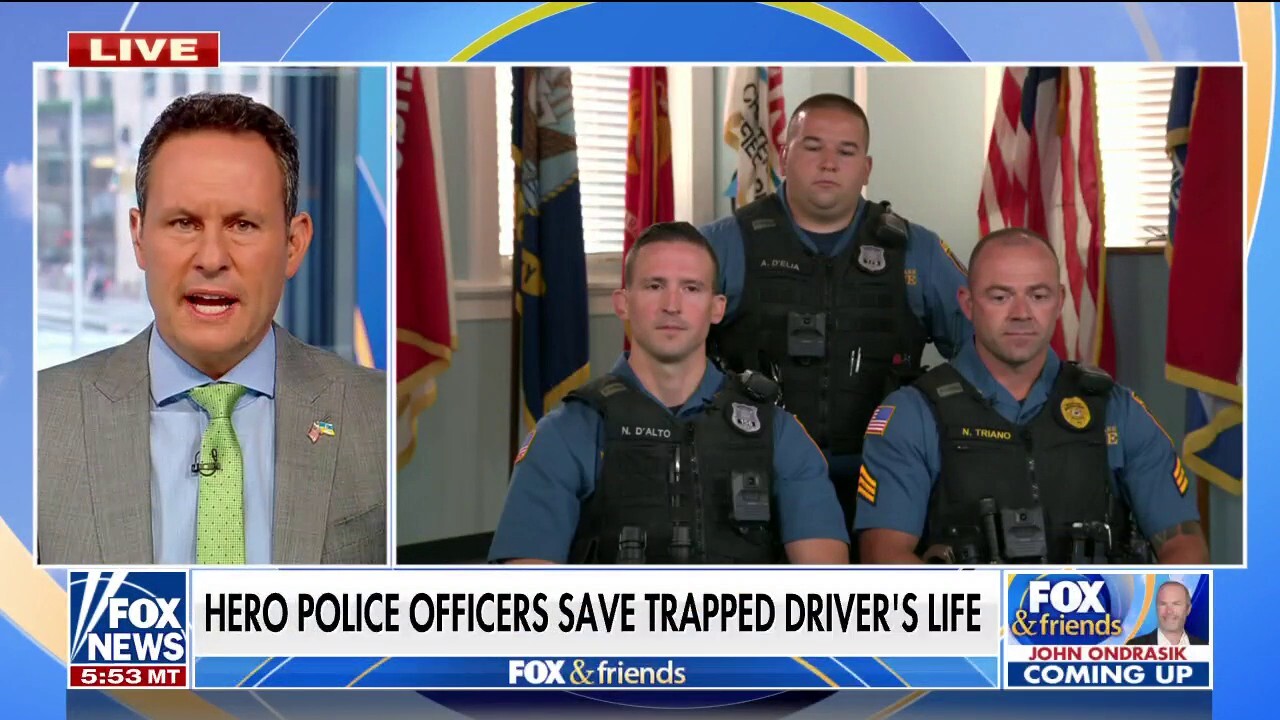 Hero police officers save man trapped in car on fire