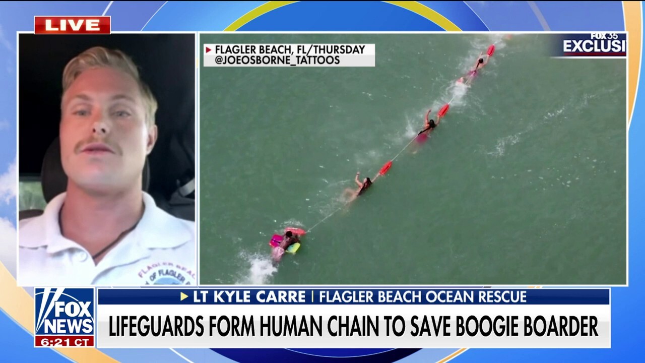 Florida lifeguards form human chain to save boogie border