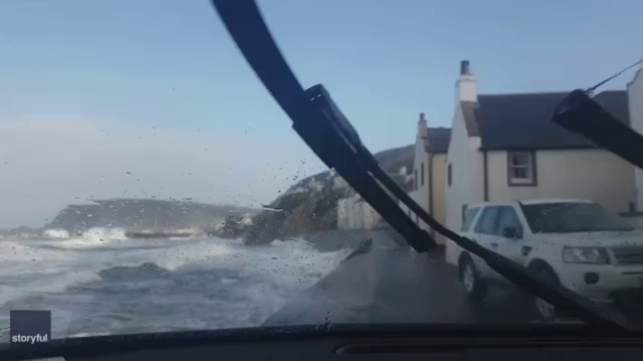Daredevil driver braves powerful waves along Scottish coast