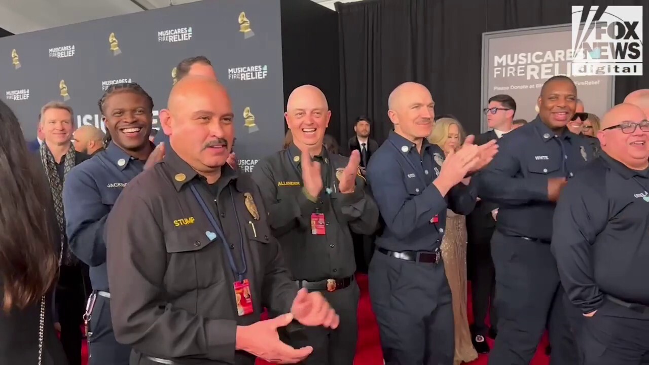 Firefighters walk the red carpet at the 2025 Grammy Awards