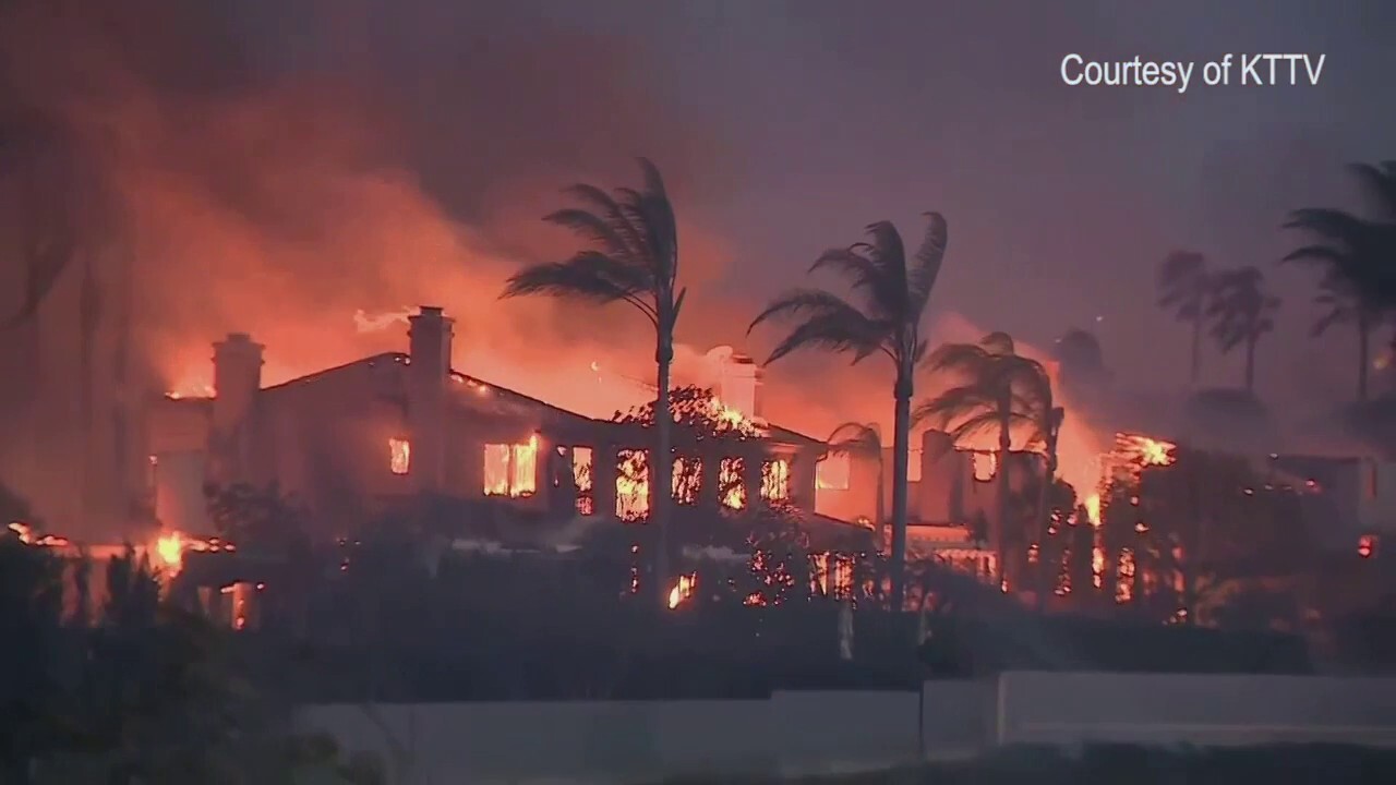 Fast-moving brush fire in Southern California engulfs multimillion-dollar homes in flames