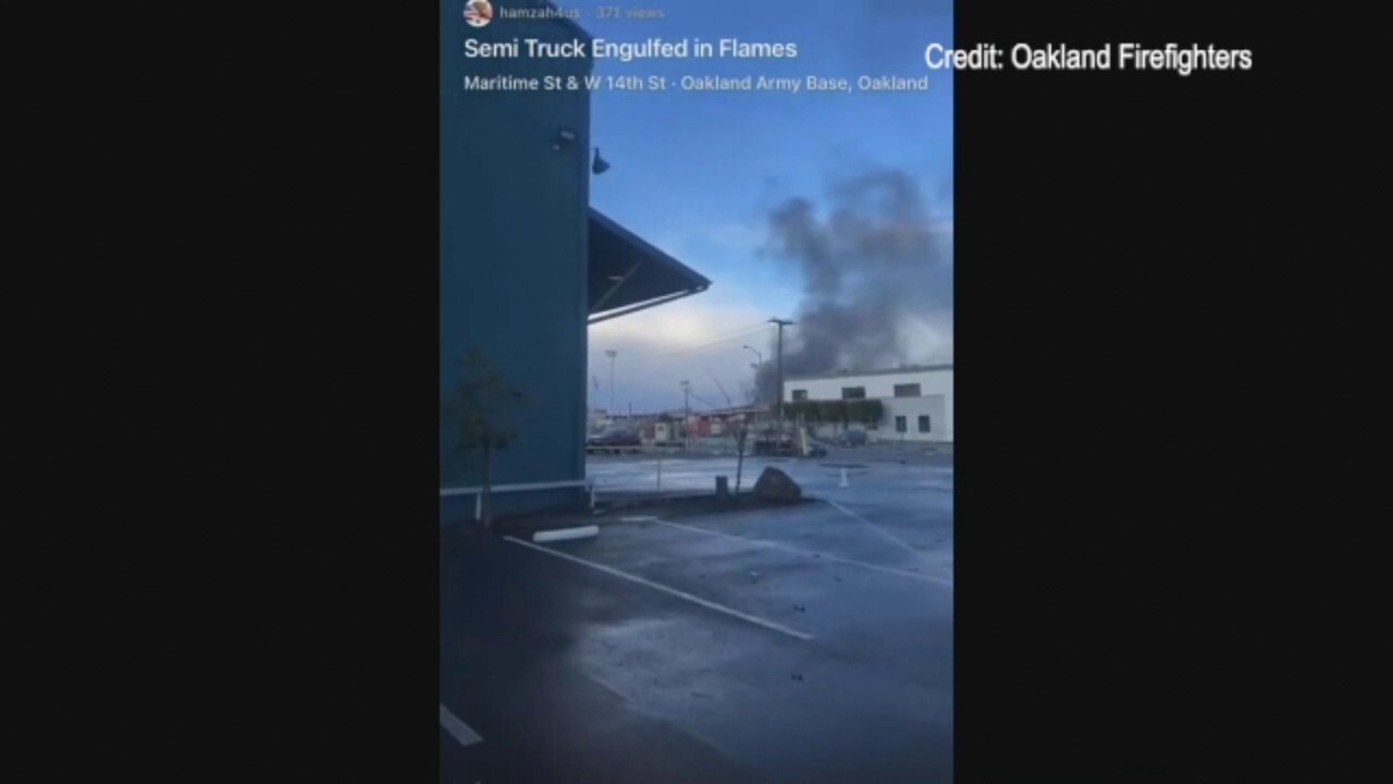 Smoke billows into the air after several big rig trucks catch on fire in Oakland, CA