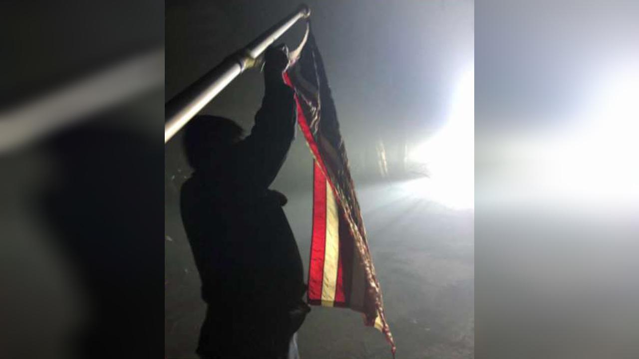American flag stands in ashes of California wildfire