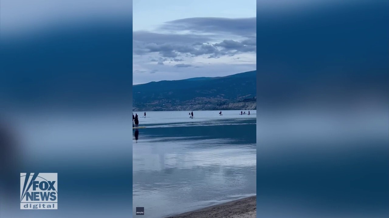 Group of 'witches' paddle across lake in odd moment caught on camera