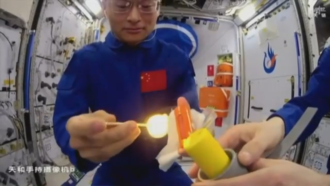 Chinese astronauts livestream while lighting an open flame in space