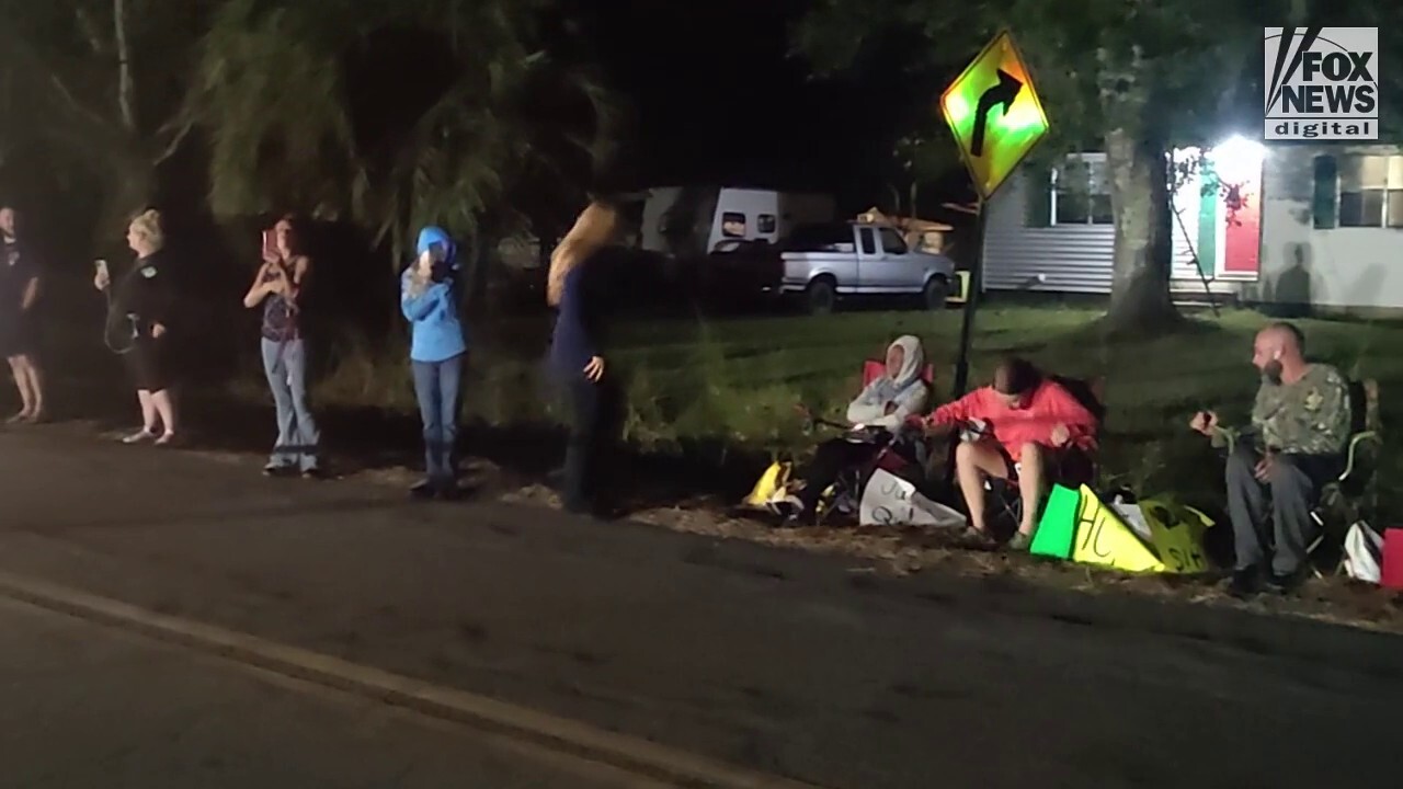 Hecklers outside the home of Leilani Simon