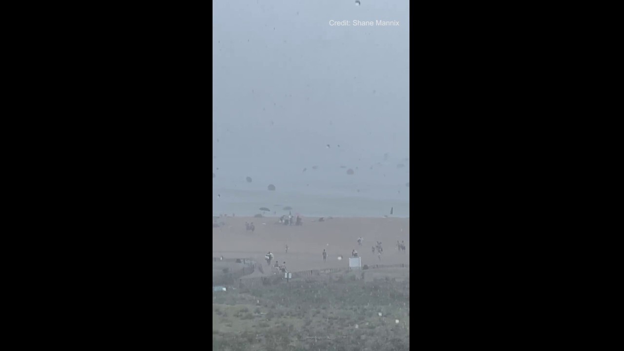 Beach umbrellas blown into the ocean as severe weather hits coastal Delaware