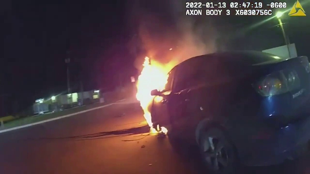 Texas police officer rescues woman trapped in burning car, bodycam video shows