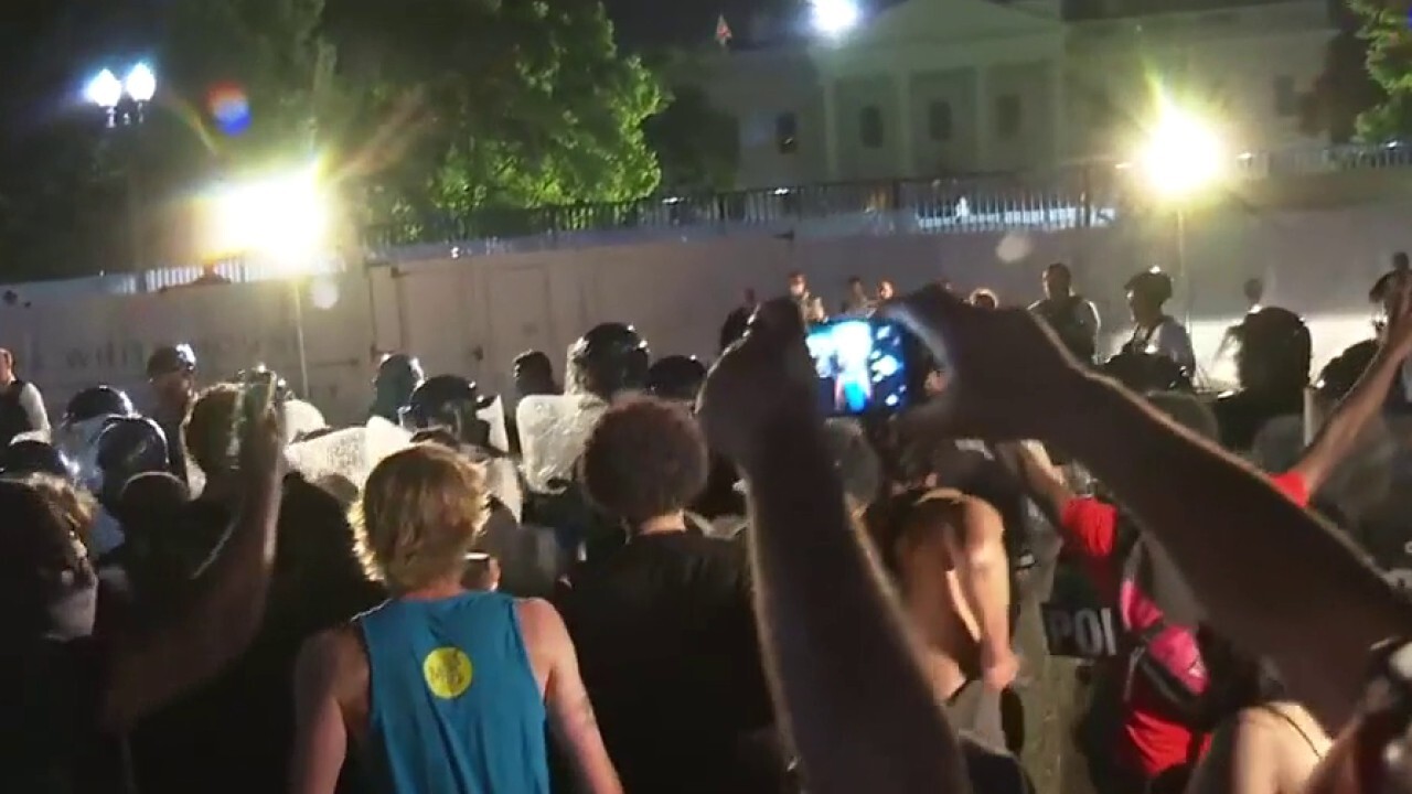 Protesters clash with Secret Service officers outside the White House