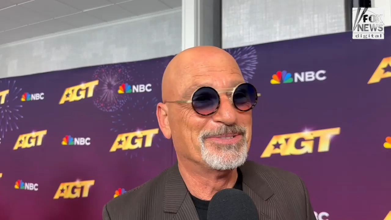 ‘AGT’ judge Howie Mandel reacts to Heidi Klum jumping onto his lap during shocking act