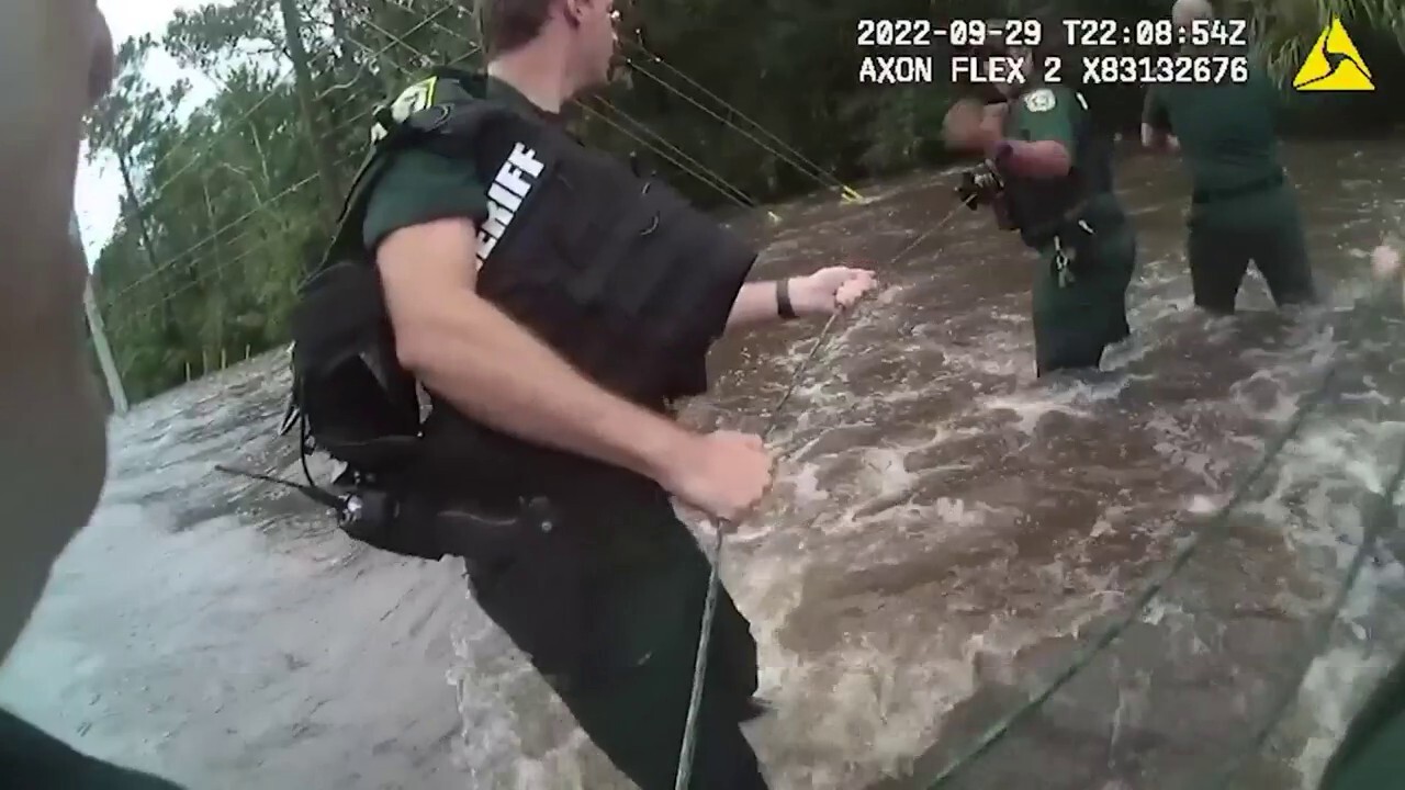 Florida deputies form human chain to rescue woman from floodwaters