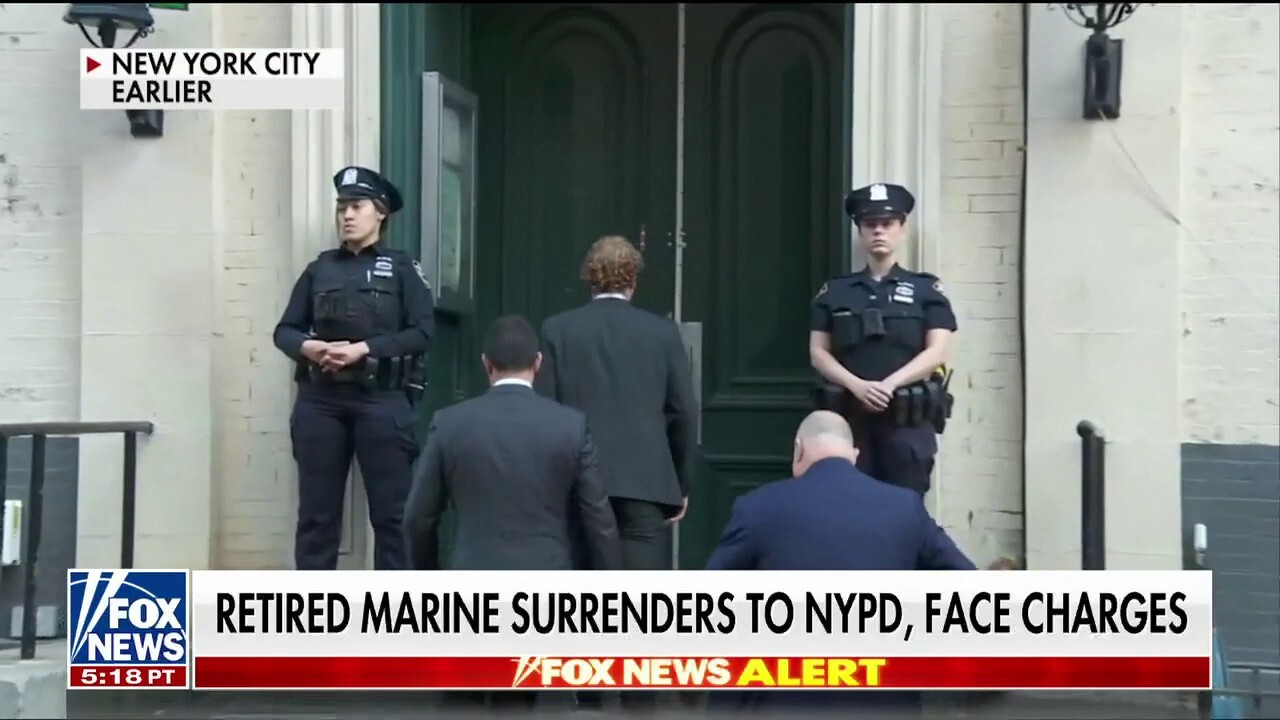 Marine veteran surrenders in NYC to face charges