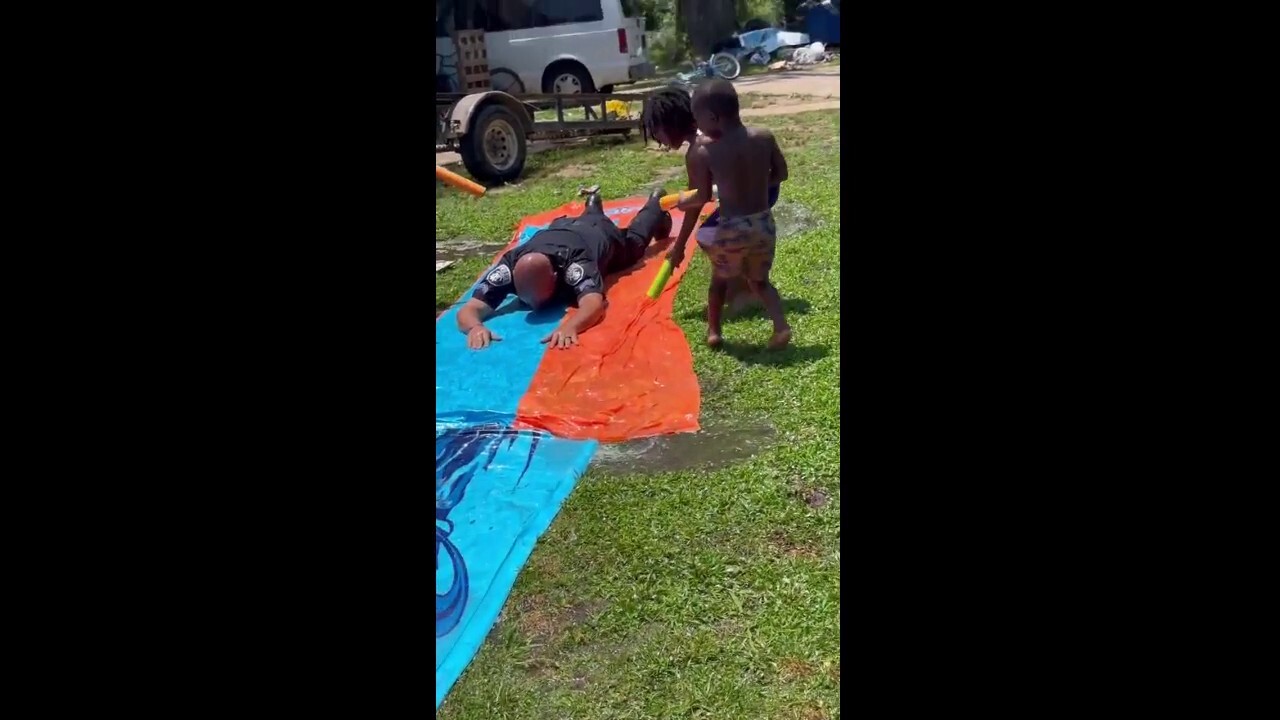 He 'beat' the heat: Police officer joins local kids in slip-and-slide in the summer heat