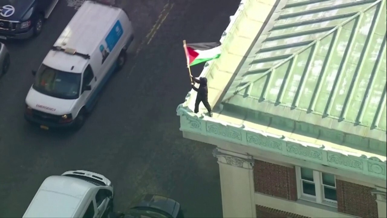 Aerial view shows an anti-Israel protester waving a Palestinian flag on the roof of Columbia's Hamilton Hall