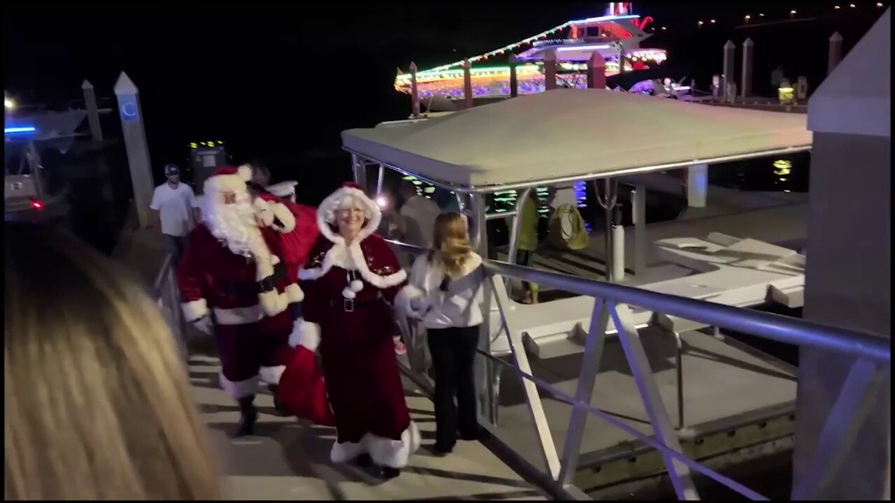 Officers with the Volusia Sheriff’s department in Florida give Santa and Mrs. Claus a boat ride to Toys for Tots event