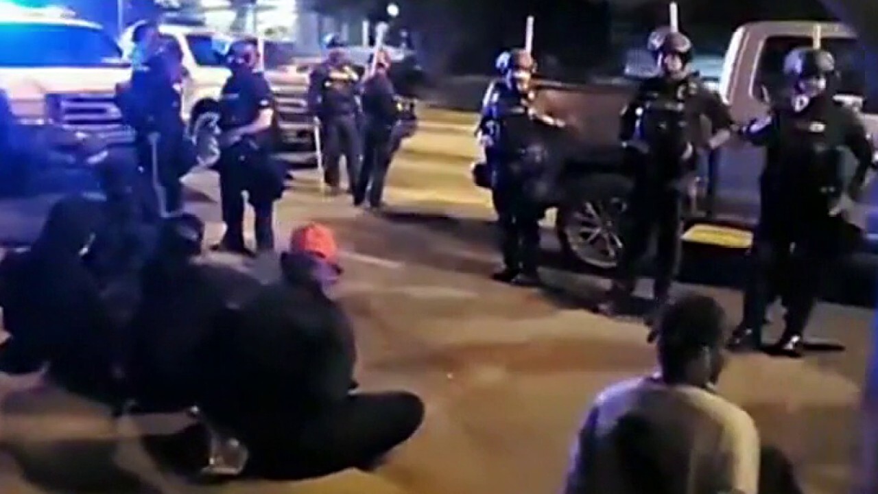 Louisville police declare 'unlawful assembly' after protesters smashed windows