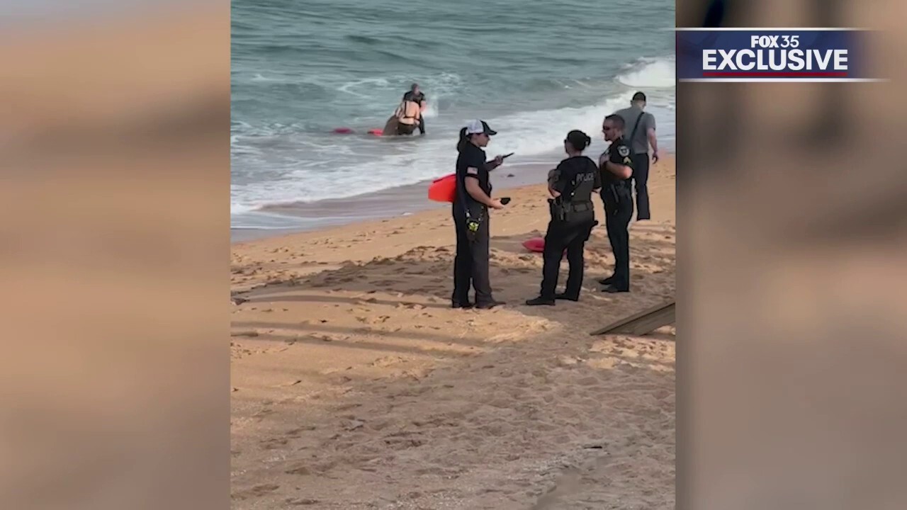 Florida police officer credited with helping rescue two struggling swimmers