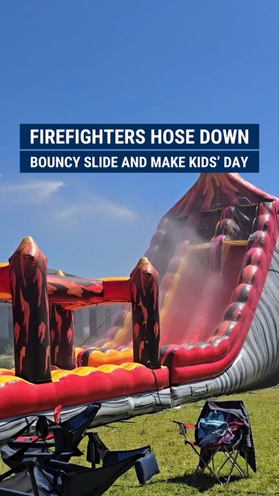 Firefighters hose down   bouncy slide, making kids' day