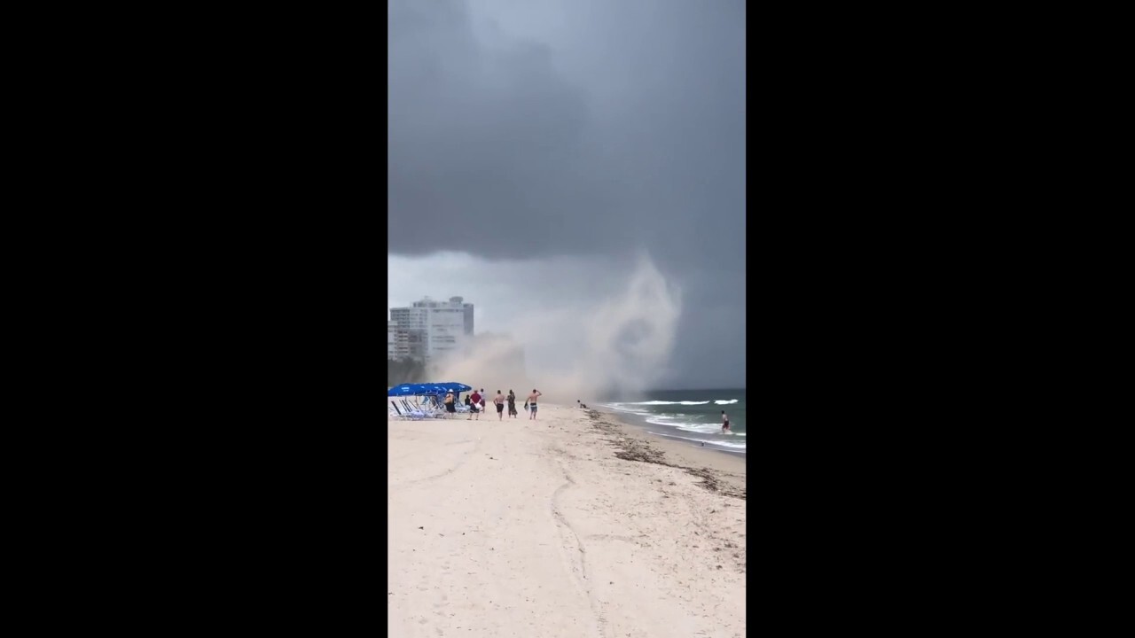 Stunning video reveals how beach storm grabbed vacationer's umbrella