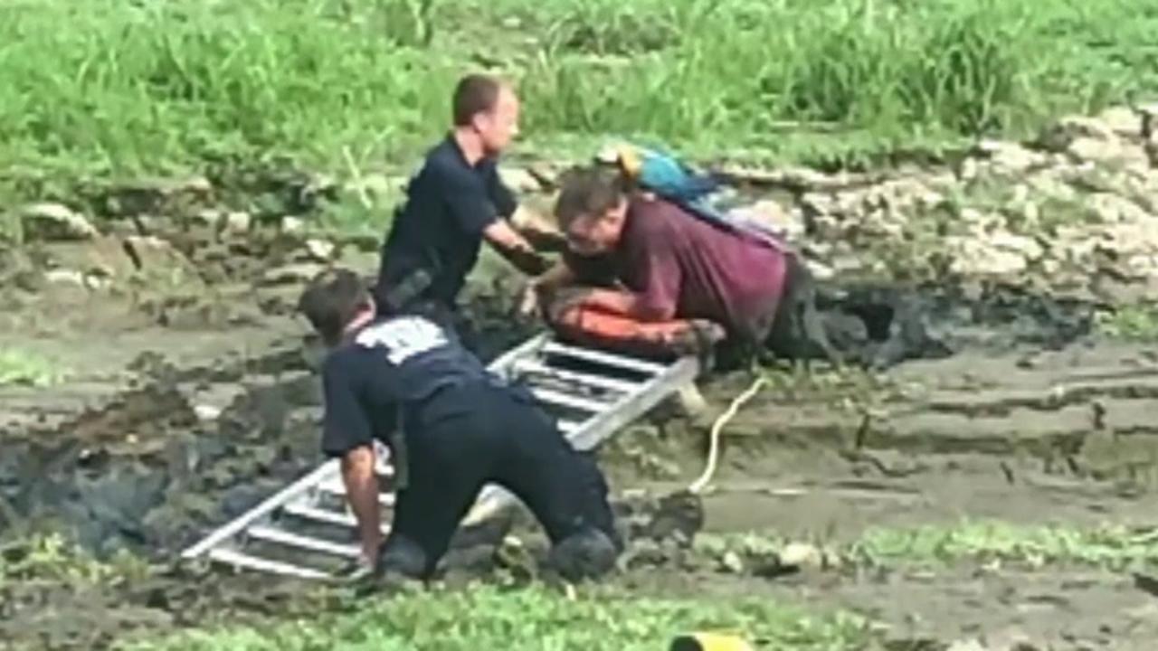 Man with parrot on his shoulder rescued from mud
