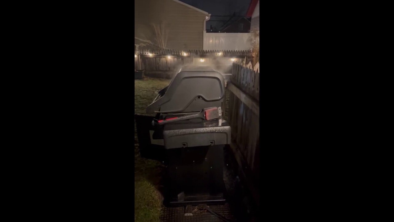 Ohio resident grills meal outside during stormy weather