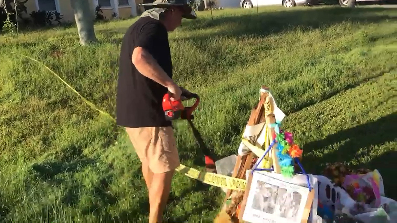 Chris Laundrie trims grass around Gabby Petito makeshift memorial set up on front lawn