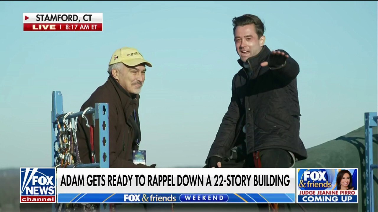 Adam Klotz prepares to rappel down a 22-story building in Connecticut