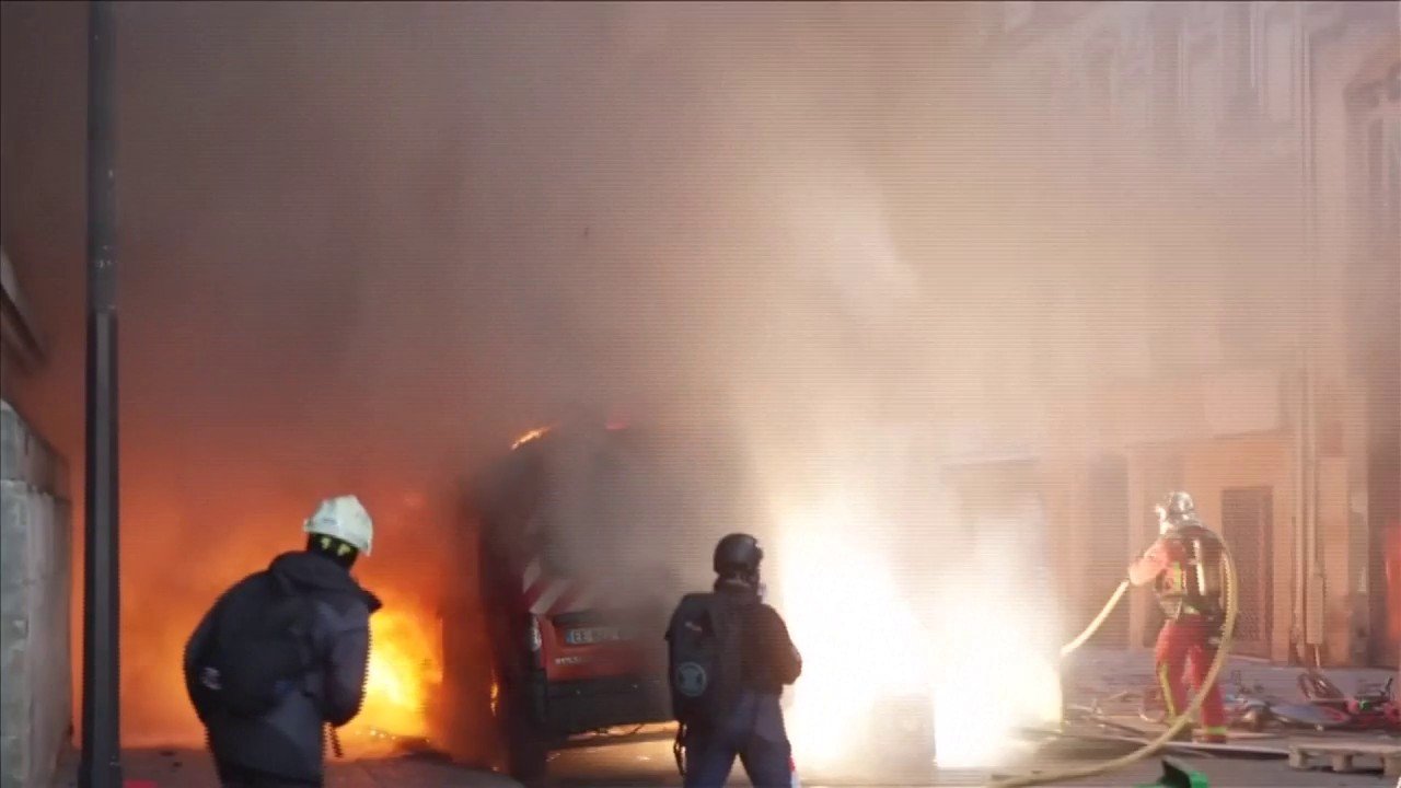 Firefighters battle car blaze amid violent Paris protests
