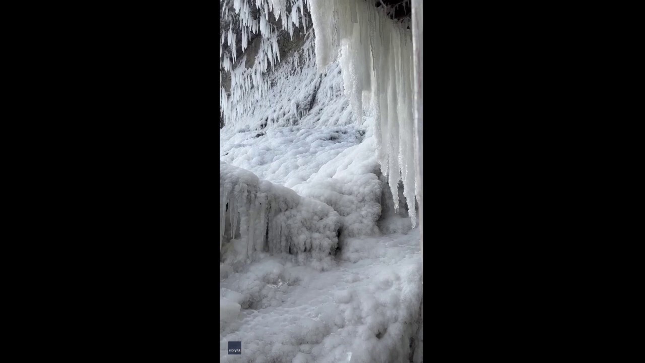 Icicles form under snow-covered Niagara Falls in Arctic blast