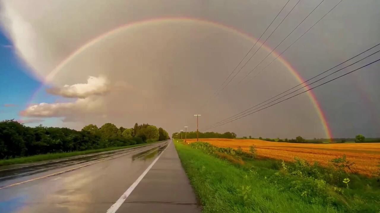 Beautiful rainbow arches across New York sky