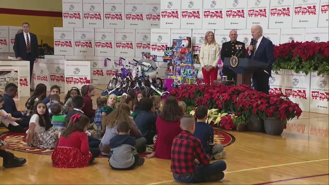 A confused Biden is escorted off stage by young girl after Toys for Tots remarks